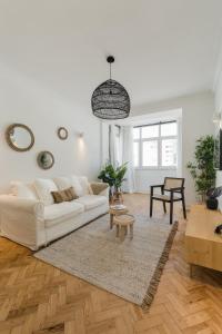 a white living room with a white couch and a rug at Casa Boma Lisboa - Shining & Spacious Apartments With Balcony - Alvalade I in Lisbon