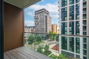 an apartment balcony with a view of a city at Modern 01 & 02 Bed Apartment in Canary Wharf in London