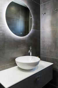 a bathroom with a white sink and a mirror at Villa Vrahinari in Kounopetra