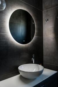 a bathroom with a large white sink and a mirror at Villa Vrahinari in Kounopetra