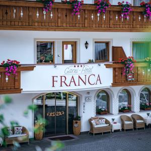 a building with a sign that reads grand hotel franca at Garni Hotel Franca b&b in Selva di Val Gardena
