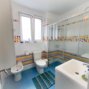 a bathroom with a toilet and a shower and a sink at City Center Apartment in Bucharest