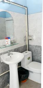 a bathroom with a white sink and a toilet at Mr.Khanh Coffee in Xuân Trường