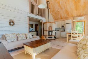 a living room with a couch and a table at Patalaiska Cottages in Ruokolahti