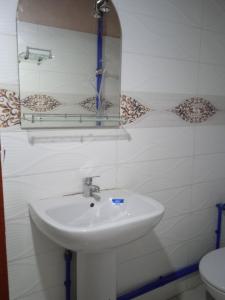 bagno con lavandino, specchio e servizi igienici di Dar Jamila a Achbarou