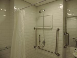 a bathroom with a shower and a shower curtain at Ramada Encore Sao Paulo Tiradentes Centro in Sao Paulo +74 photos