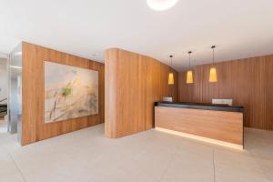 a lobby with wooden walls and a reception desk at Eurostars Pórtico Alicante in Alicante