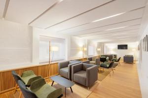 a waiting room with couches and chairs at Eurostars Pórtico Alicante in Alicante