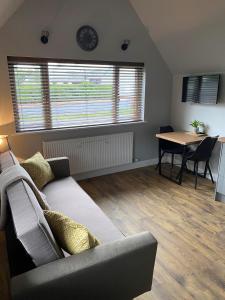 a living room with a couch and a table at 12 North Street in Sandwick