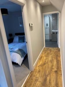 a bedroom with a bed and a bathroom at 12 North Street in Sandwick