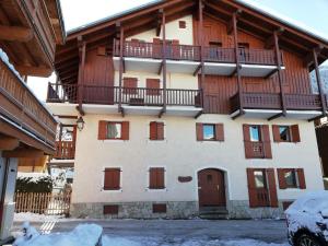 Saint-Bon-TarentaiseにあるAppartement Courchevel, 2 pièces, 5 personnes - FR-1-514-2のバルコニー付きのアパートメントで、地面に雪が降ります。