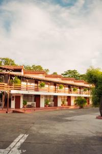 a red and white building with a parking lot at Hotel Faranda Bolivar Cucuta, a member of Radisson Individuals in Cúcuta