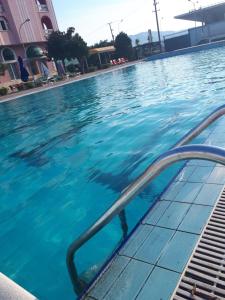 a swimming pool with blue water in a building at Hotel Meteor in Shkodër