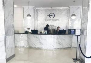 a lobby with two people sitting at a counter at Ocean Reserve 207 - STR 2270 in Miami Beach