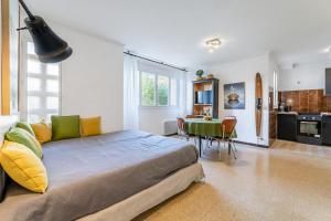 ein Schlafzimmer mit einem großen Bett und einem Tisch mit Stühlen in der Unterkunft Le Marignan- Studio plein centre in Cassis