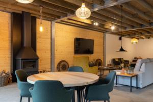 a room with a table and chairs and a fireplace at Sóis Montejunto Eco Lodge in Alenquer