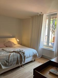a bedroom with a bed and a large window at Maison Henri Namur in Namur
