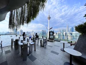 a restaurant with tables and chairs and a view of the city at KLCC View Grand Studio Suites ceylonz in Kuala Lumpur