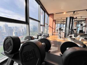 a gym with a view of a city skyline at KLCC View Grand Studio Suites ceylonz in Kuala Lumpur