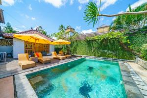 an image of a swimming pool in a villa at Black Pearl Hostel in Canggu