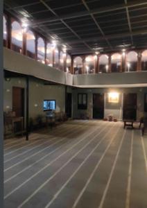 an empty room with a dance floor with a television at Sukh Sagar Hotel in Jaipur