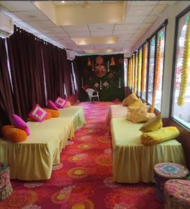 a row of three beds in a train room at Sukh Sagar Hotel in Jaipur