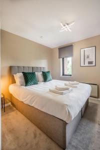 a large white bed in a room with a window at Waterlily Apartment - Beautiful 1-bed with overlooking balcony in Nottingham