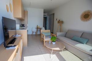 a living room with a couch and a table at Greek Beach House A3 Lefkada in Nydri