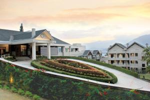 a house with a garden in front of it at Sinclairs Retreat Kalimpong in Kalimpong