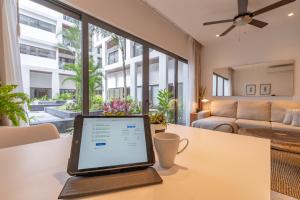 a laptop computer sitting on a table in a living room at Always Playa at IPANA in Playa del Carmen