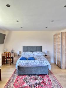 a bedroom with a large bed and a rug at Loch Morar Private Suite in Mallaig