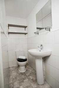 a white bathroom with a sink and a toilet at Flat 1 Bellevue in Bristol