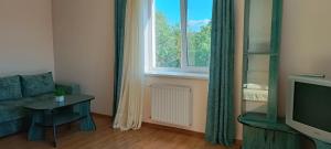 a living room with a couch and a window at Cozy Two room apartment in Mukacheve