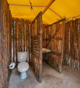a wooden bathroom with a toilet and a sink at Glamping San Isidro in Laguna de Sánchez