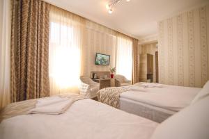 Postel nebo postele na pokoji v ubytování Hotel Kera
