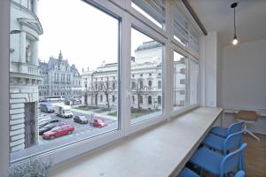 a room with a large window with a view of a city at City Hall view Apartment Liberec in Liberec