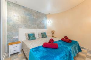 a bedroom with two beds with red shoes on them at Luxury two-bedroom apartment Four Seasons in Adeje