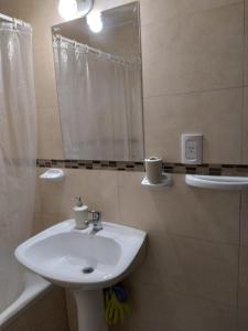 a bathroom with a sink and a mirror at Terracota lodge in Guaymallen