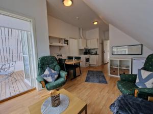 a living room with two chairs and a table at Undredal Fjord Apartments in Undredal +19 photos