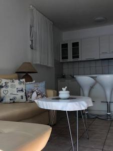 a living room with a couch and a table at Apartment Bonaca in Komarna