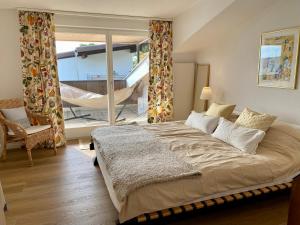 Oberägeri的住宿－Beautiful apartment with fantastic views，一间带大床的卧室和一个阳台