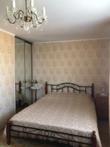 1 dormitorio con cama y lámpara de araña en Künni majutus en Viljandi