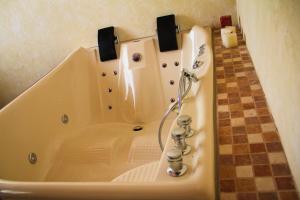 a bath tub with a shower in a bathroom at MAJU HOTEL CAMPESTRE & SPA in Jamapa