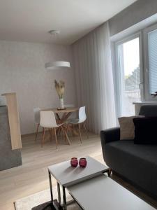 a living room with a couch and a table at Apartman Hestia in Rajecké Teplice