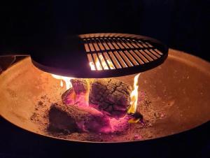 a pot with a fire inside of it at The Owls Rest Shepherds Hut Hethel in Norwich