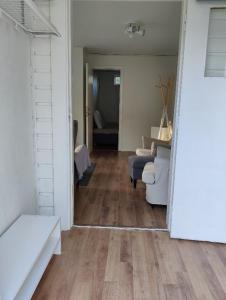 a living room with white furniture and a wooden floor at House. 80m2, near Lake, with car charge. in Sommarbo
