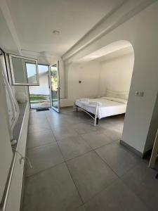 a bedroom with a bed and a large window at Residenza Margot in Quattromiglio