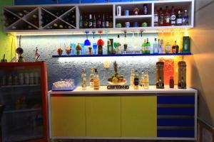 a colorful bar in a room with alcohol on the wall at Hostel Cores do Pelô in Salvador