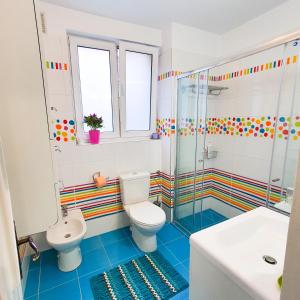 a bathroom with a toilet and a shower and a sink at City Center Apartment in Bucharest