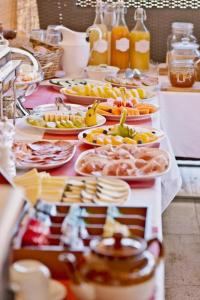 a buffet with many plates of food on a table at Argileto Aqua in Rome